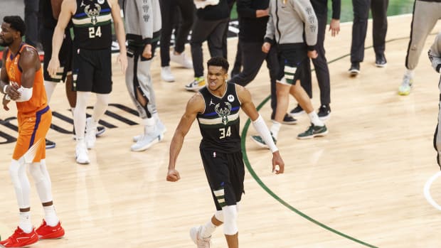 Milwaukee Bucks forward Giannis Antetokounmpo (34) begins to celebrate